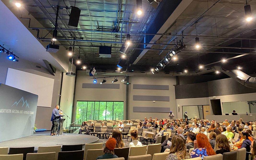 wide shot of Ethan speaking at 2025 Summit